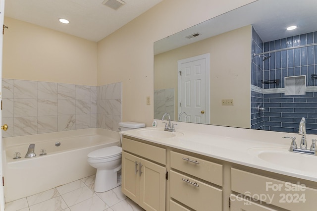 full bathroom featuring tiled shower / bath, vanity, and toilet