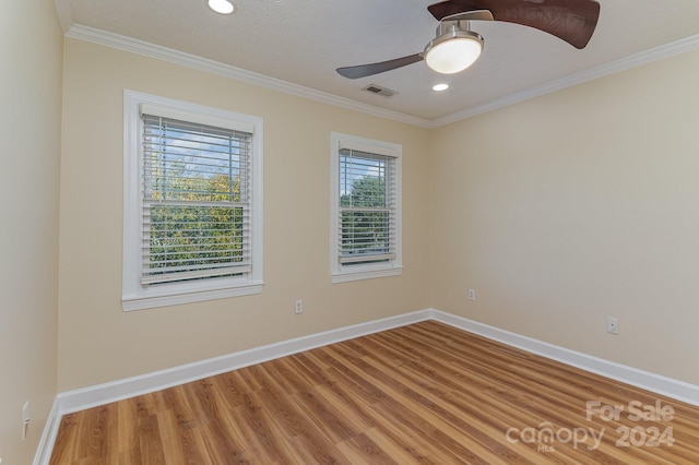 empty room with ceiling fan, a textured ceiling, wood-type flooring, and ornamental molding