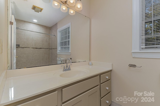 bathroom featuring vanity and a tile shower