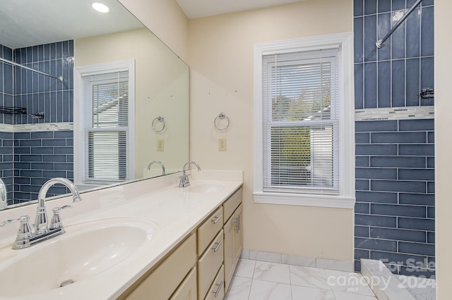 bathroom with vanity and tiled shower