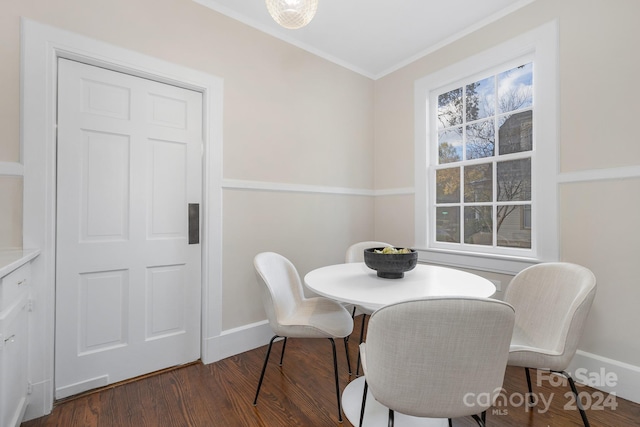 dining area with dark hardwood / wood-style flooring and ornamental molding