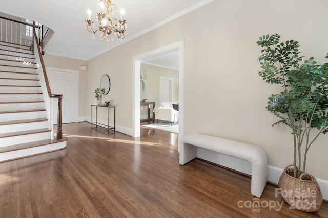 foyer entrance featuring ornamental molding, a chandelier, and dark hardwood / wood-style floors