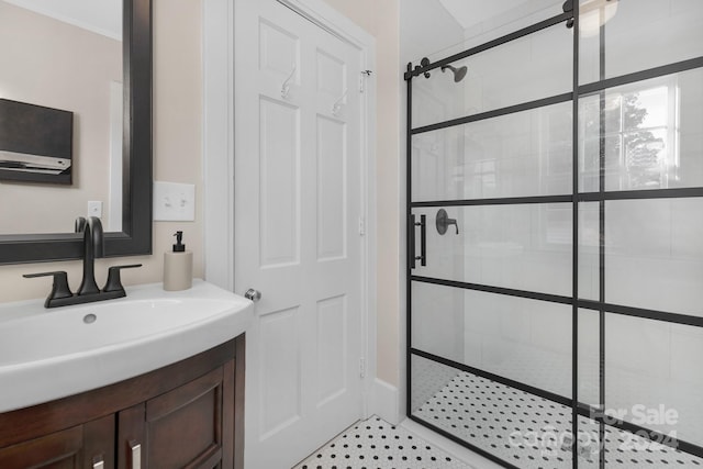 bathroom featuring vanity and a shower with shower door