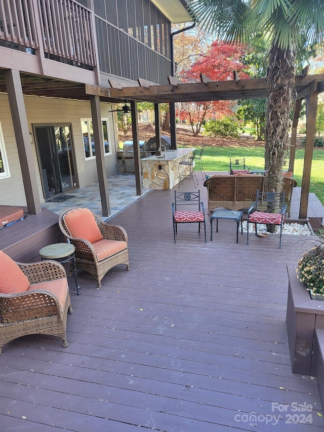 wooden deck featuring an outdoor kitchen and an outdoor hangout area