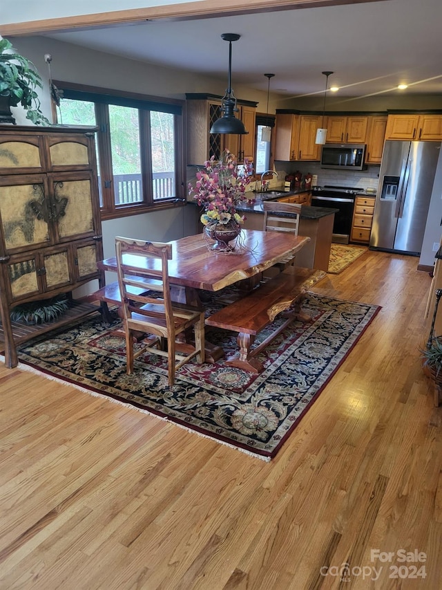 dining room featuring light wood-type flooring and sink