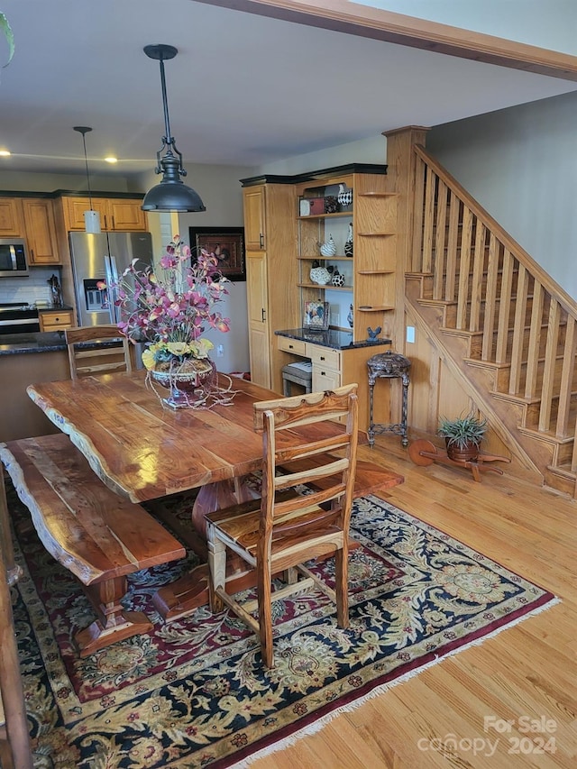 dining space with hardwood / wood-style flooring