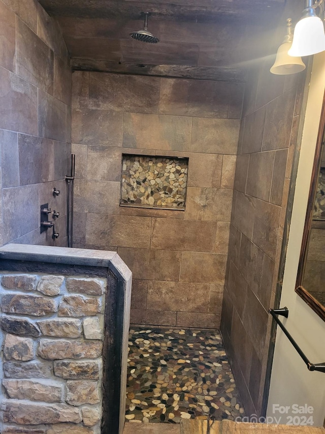 bathroom with tiled shower