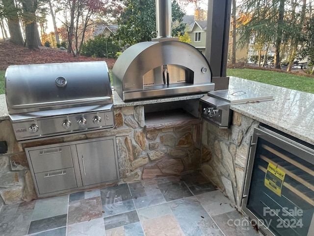 view of patio featuring wine cooler, area for grilling, and grilling area