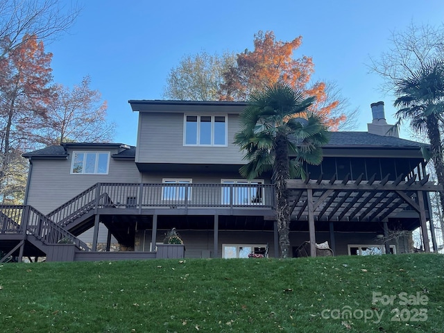 back of property featuring a yard, stairway, a chimney, and a wooden deck