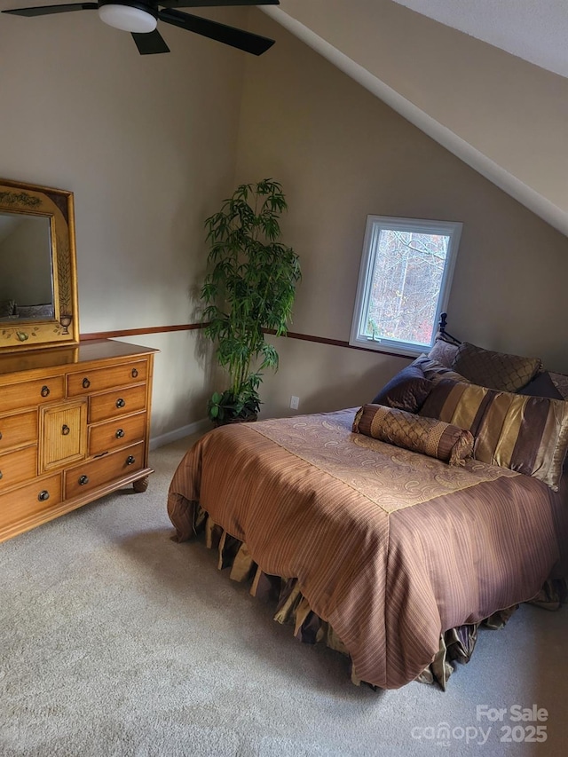 carpeted bedroom featuring ceiling fan and vaulted ceiling