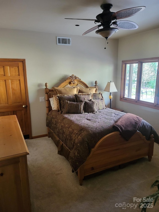 bedroom with visible vents, ceiling fan, light carpet, and baseboards