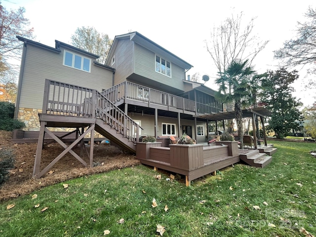 back of property with stairway, a deck, and a yard