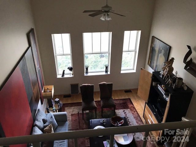 living room with ceiling fan and hardwood / wood-style floors