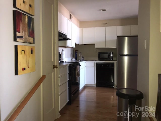 kitchen featuring black appliances, dark hardwood / wood-style floors, and white cabinets