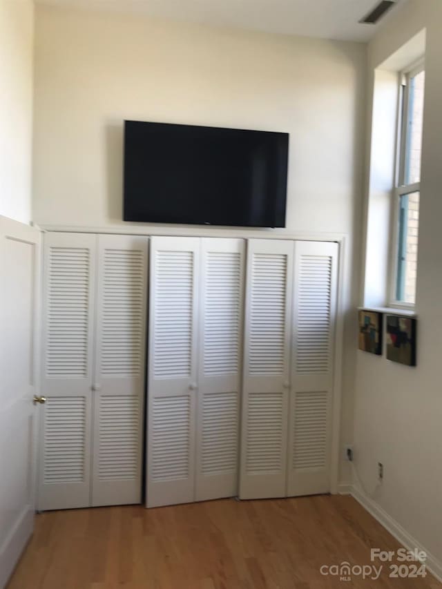 interior space with hardwood / wood-style flooring and a closet