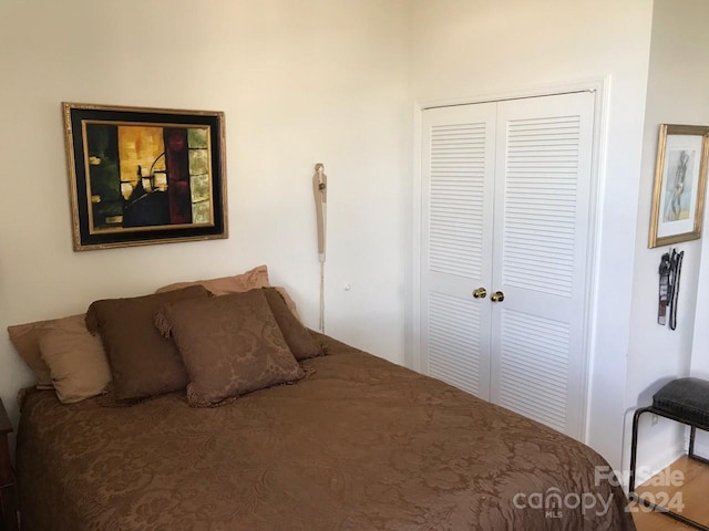 bedroom with hardwood / wood-style flooring and a closet