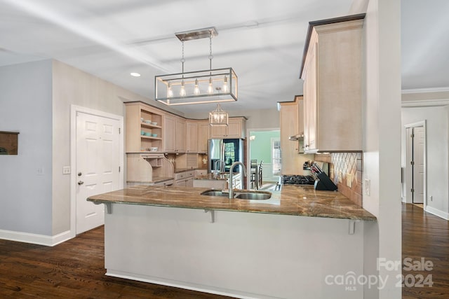 kitchen with pendant lighting, kitchen peninsula, dark wood-type flooring, and light brown cabinetry