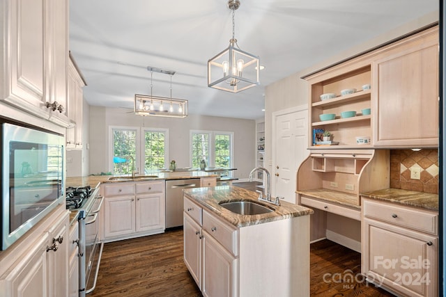 kitchen featuring sink, hanging light fixtures, kitchen peninsula, a center island with sink, and appliances with stainless steel finishes