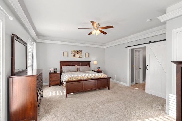 bedroom featuring ceiling fan, a barn door, light colored carpet, and crown molding