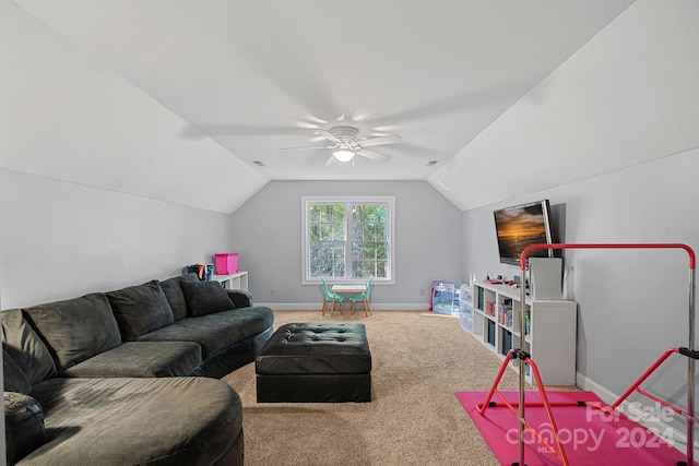 carpeted living room with ceiling fan and vaulted ceiling