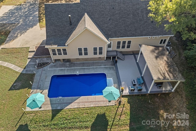 view of pool with a lawn and a patio