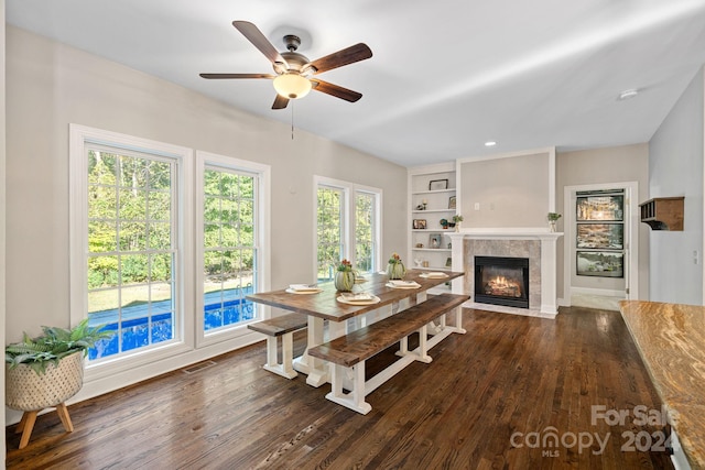 dining room with ceiling fan, built in features, and dark hardwood / wood-style floors