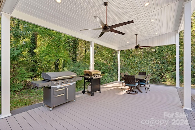 wooden terrace featuring grilling area and ceiling fan