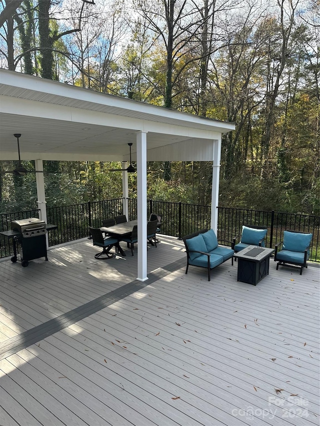 wooden deck with an outdoor living space and grilling area