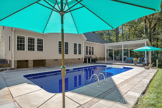 view of pool with outdoor lounge area and a patio