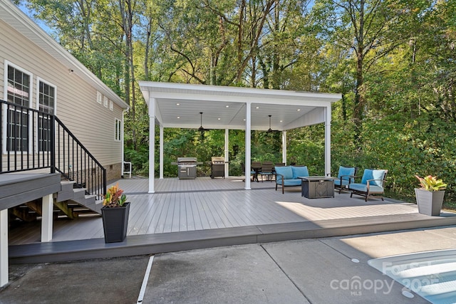 view of patio / terrace featuring an outdoor living space with a fire pit, a deck, and grilling area