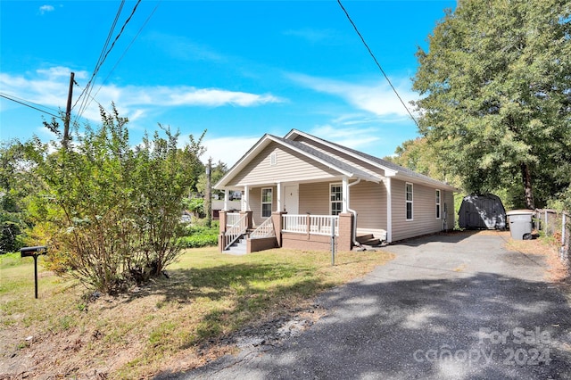 view of front of home with a front yard and a porch