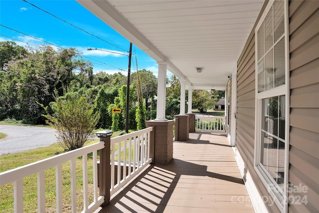 wooden terrace featuring covered porch