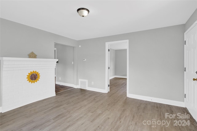 unfurnished living room featuring hardwood / wood-style flooring