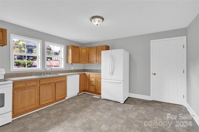 kitchen featuring white appliances and sink