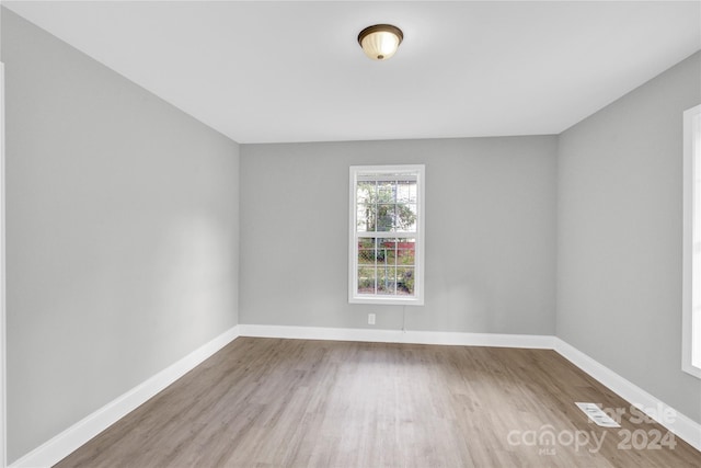 empty room with hardwood / wood-style floors