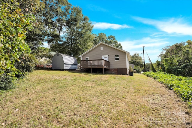 view of yard with a storage shed and a deck