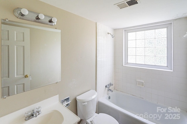 bathroom with bathtub / shower combination, visible vents, vanity, and toilet