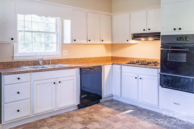 kitchen featuring white cabinets, under cabinet range hood, black appliances, a sink, and a warming drawer