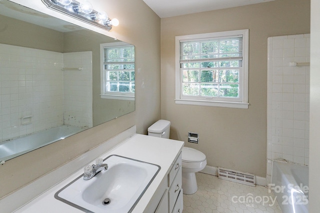 bathroom featuring toilet, visible vents, vanity, baseboards, and tile patterned floors