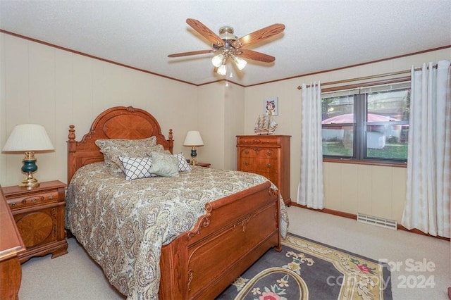 carpeted bedroom featuring crown molding, a textured ceiling, and ceiling fan