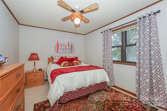 carpeted bedroom with ornamental molding and ceiling fan