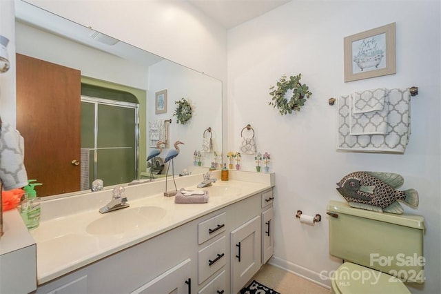 bathroom featuring toilet, walk in shower, and vanity