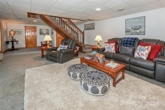 living room featuring a paneled ceiling and carpet