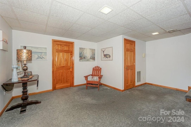 unfurnished room with a drop ceiling and carpet floors