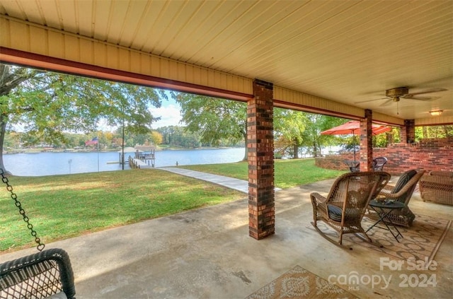 view of patio / terrace with a water view and ceiling fan