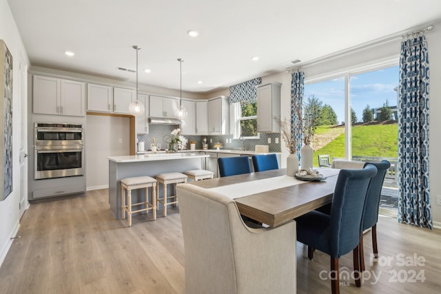 dining area featuring sink and light hardwood / wood-style flooring