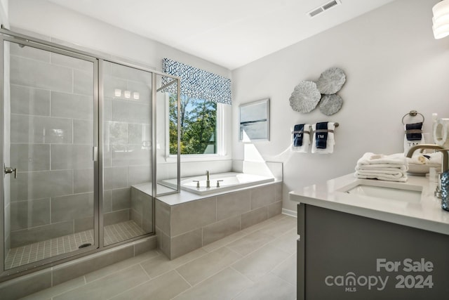 bathroom with vanity, plus walk in shower, and tile patterned floors