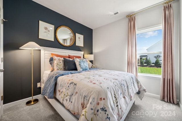 bedroom featuring multiple windows and carpet floors