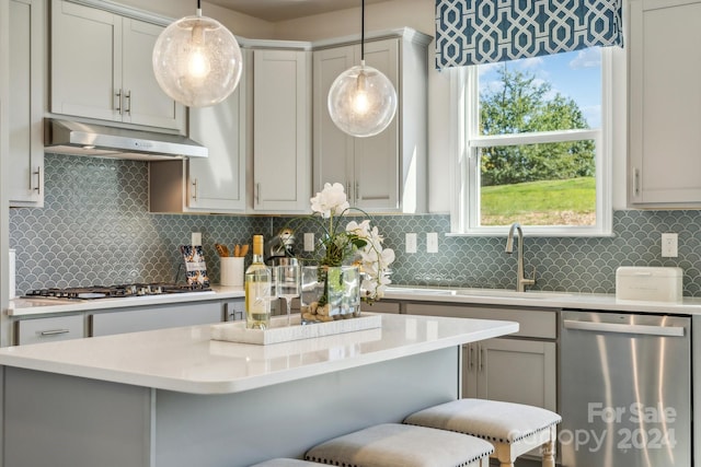 kitchen featuring decorative backsplash, decorative light fixtures, and stainless steel appliances