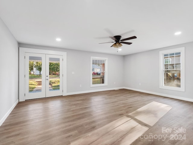 empty room featuring french doors, light hardwood / wood-style floors, and ceiling fan